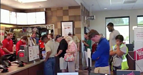 Customers Bow their Heads to Pray for a Chick-Fil-A Staff Undergoing Cancer Surgery